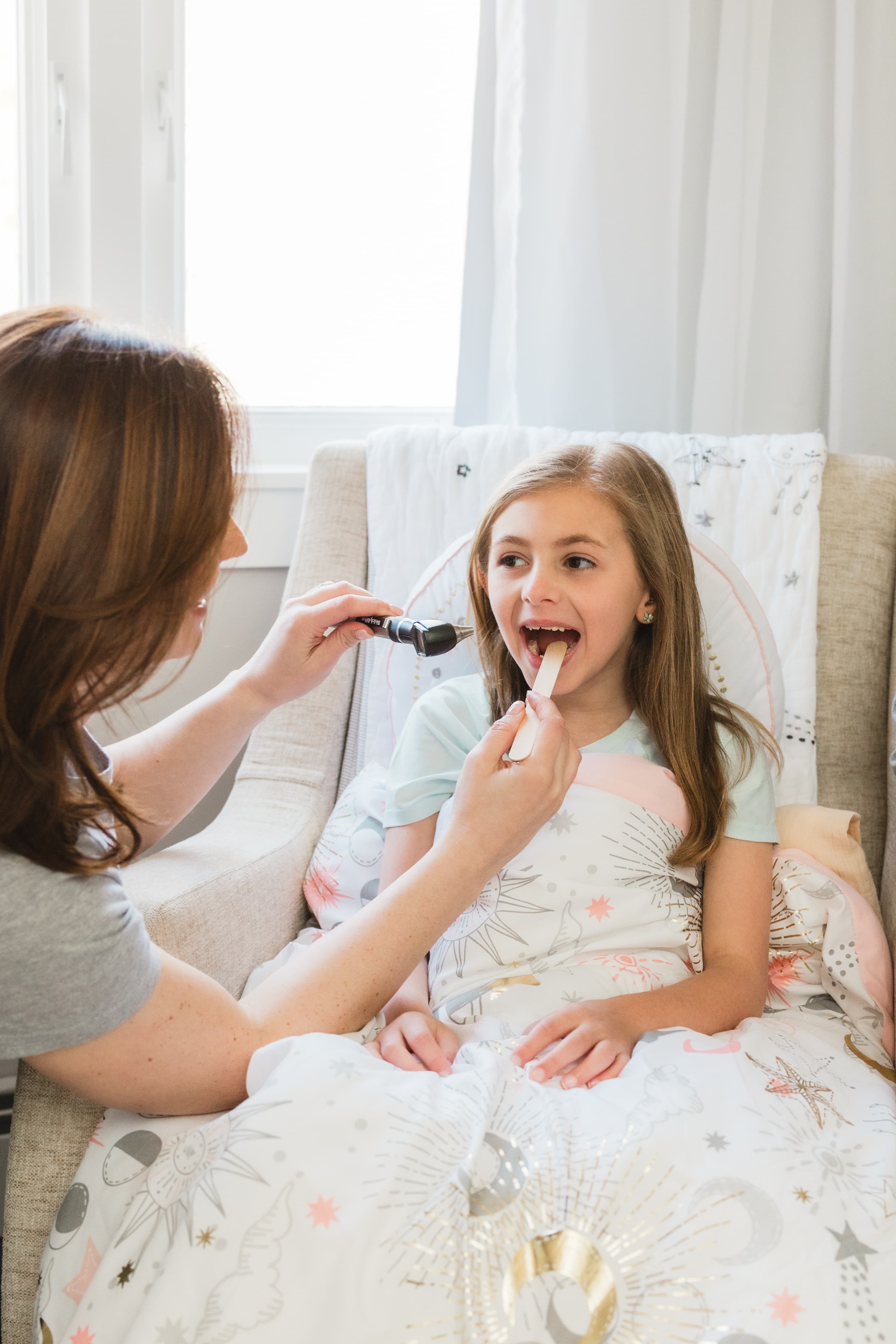 Pediatrician providing compassionate sick-visit care for a child